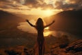 The girl raised her hands to the sun against the backdrop of the mountains. Healthy lifestyle, travel concept