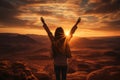 The girl raised her hands to the sun against the backdrop of the mountains. Healthy lifestyle, travel concept