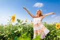 Girl raises her hands to sky on flower field Royalty Free Stock Photo