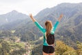 Girl raising her hands in happiness, celebrating hiking success