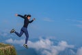 The girl ran, jumped from a high place and ran in a mountainous field