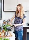 Girl with raw fish in fryingpan Royalty Free Stock Photo