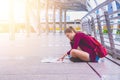 A girl read map in town.A lone girl red bag holding  map and searching road to house. Royalty Free Stock Photo