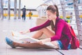 A girl read map in town.A lone girl red bag holding  map and searching road to house. Royalty Free Stock Photo