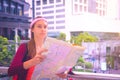 A girl read map in town.A lone girl red bag holding  map and searching road to house. Royalty Free Stock Photo