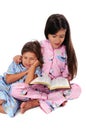 Girl Reading Bedtime Story to Sister