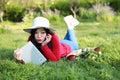 Girl reading the book. beautiful young woman with book lying on the grass. Outdoor. Sunny day Royalty Free Stock Photo