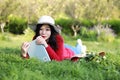 Girl reading the book. beautiful young woman with book lying on the grass. Outdoor. Sunny day Royalty Free Stock Photo