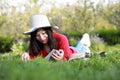 Girl reading the book. beautiful young woman with book lying on the grass. Outdoor. Sunny day Royalty Free Stock Photo