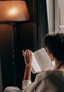 Girl reading book bed evening weekend alone Royalty Free Stock Photo