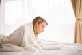 Girl reading a book in bed, lying on her stomach smiling Royalty Free Stock Photo