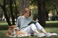 Girl reading a book on the lawn Royalty Free Stock Photo