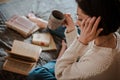 Girl reading a book and drinking coffee in bed feet on the wall. Royalty Free Stock Photo