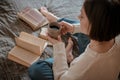 Girl reading a book and drinking coffee in bed feet on the wall. Royalty Free Stock Photo