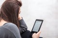 Girl is reading a book with an e-book reader Royalty Free Stock Photo