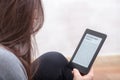 Girl is reading a book with an e-book reader Royalty Free Stock Photo