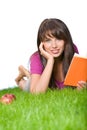 Girl reading book in the grass