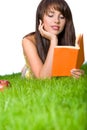 Girl reading book in the grass