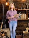 Girl reading book in house of gamekeeper. Vintage concept. Lady blonde on calm face in plaid clothes holds book, reading