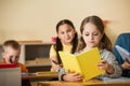 girl reading book during leson in