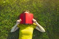 Girl reading book lying in grass