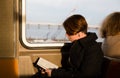 Girl reading a book in the New York subway wagon