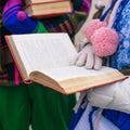 A girl is reading a book. Opened book in the hands of a young woman. Educational process. Lecture for students or poetic, literary