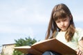 Girl reading a book, outdoor scene Royalty Free Stock Photo