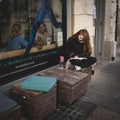 Girl reading a book outside a cafÃÂ¨ in Notting Hill. London UK. March 2017. Squared format