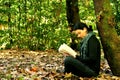 Girl reading a book in a park Royalty Free Stock Photo