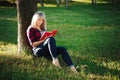 Girl reading a book in park, woman, green Royalty Free Stock Photo