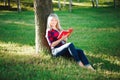 Girl reading a book in park, woman, green Royalty Free Stock Photo