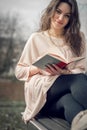 Girl reading a book in park