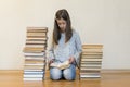 Girl reading a book sitting on the floor in an apartment. Cute girl reading book at home. education and school concept - little Royalty Free Stock Photo