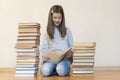 Girl reading a book sitting on the floor in an apartment. Cute girl reading book at home. education and school concept - little Royalty Free Stock Photo