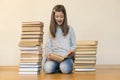 Girl reading a book sitting on the floor in an apartment. Cute girl reading book at home. education and school concept - little Royalty Free Stock Photo