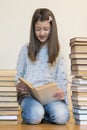 Girl reading a book sitting on the floor in an apartment. Cute girl reading book at home. education and school concept - little Royalty Free Stock Photo