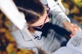 Girl reading a book while sitting on a garden swing - shot from Royalty Free Stock Photo