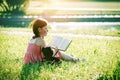 Girl reading book with teddy bear toy Royalty Free Stock Photo