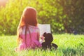 Girl reading book with teddy bear toy Royalty Free Stock Photo