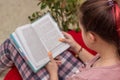 Girl reading a book, top view, partial focus