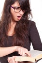 Girl reading a book and wearing big glasses Royalty Free Stock Photo