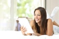 Girl reading an ebook on the bed Royalty Free Stock Photo