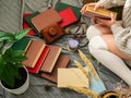 Girl reading an old book. A girl in a knitted sweater surrounded by many books Royalty Free Stock Photo