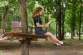 A girl is reading in the park.