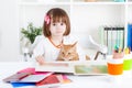 Girl reading a picture book with her cat Royalty Free Stock Photo