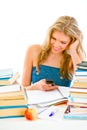 Girl reading sms instead of doing homework Royalty Free Stock Photo