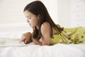 Girl Reading Story Book In Bed Royalty Free Stock Photo