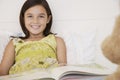 Girl Reading Story Book To Her Teddy Bear Royalty Free Stock Photo