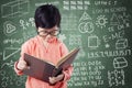 Girl reads book with doodles on chalkboard Royalty Free Stock Photo